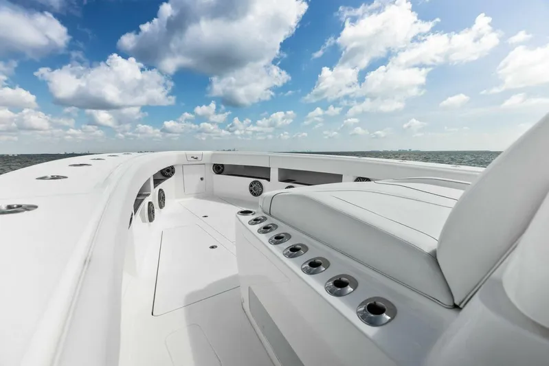 Fish Wish Yacht Photos Pics 2023 SeaVee 450z boat deck with seating, under a bright blue sky.