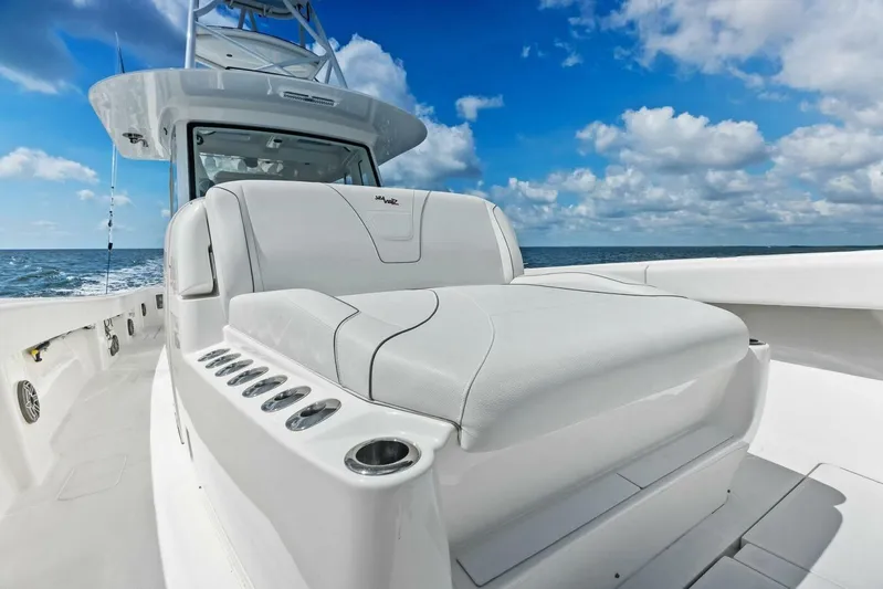 Fish Wish Yacht Photos Pics 2023 SeaVee 450z boat with sleek seating, ocean backdrop, and clear blue sky.