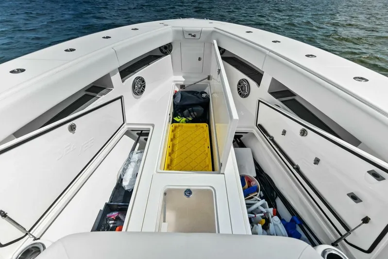Fish Wish Yacht Photos Pics 2023 SeaVee 450z boat interior with open storage compartments and ocean view.