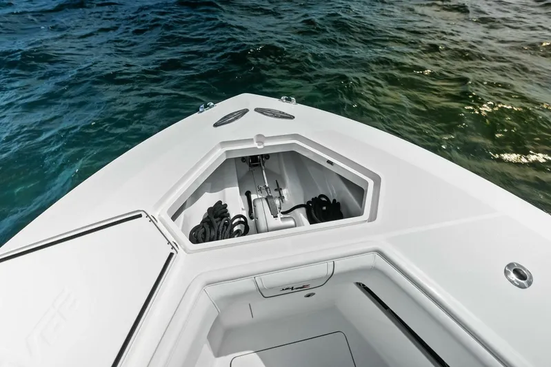 Fish Wish Yacht Photos Pics 2023 SeaVee 450z boat bow with anchor storage, on calm water.