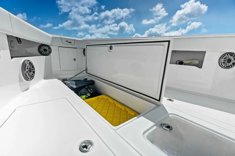 Fish Wish Yacht Photos Pics 2023 SeaVee 450z boat storage compartment with speakers and clear sky background.