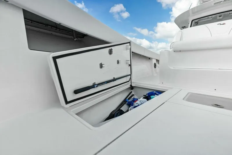 Fish Wish Yacht Photos Pics 2023 SeaVee 450z boat storage compartment with open hatch, showcasing interior space.