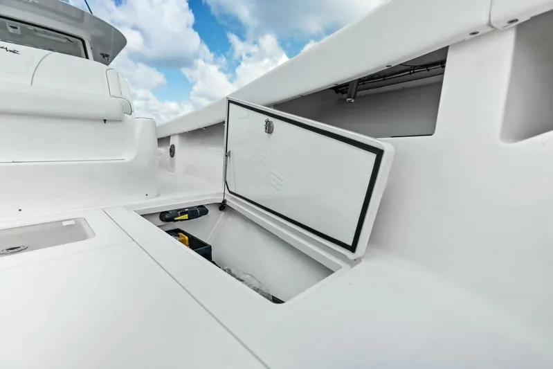 Fish Wish Yacht Photos Pics 2023 SeaVee 450z boat storage compartment with open hatch under a blue sky.