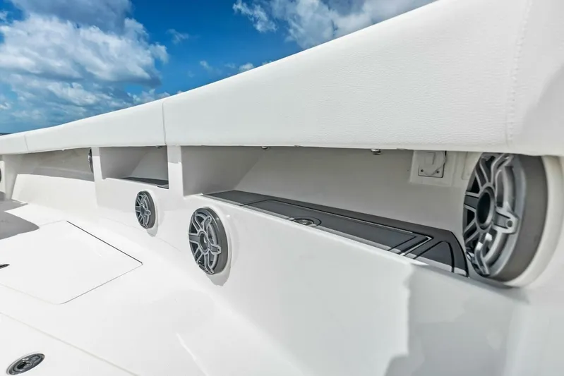Fish Wish Yacht Photos Pics 2023 SeaVee 450z boat interior with speakers and storage compartments under a blue sky.