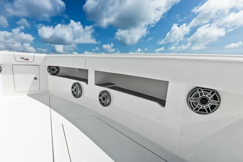 Fish Wish Yacht Photos Pics 2023 SeaVee 450z boat deck with speakers under a blue sky.