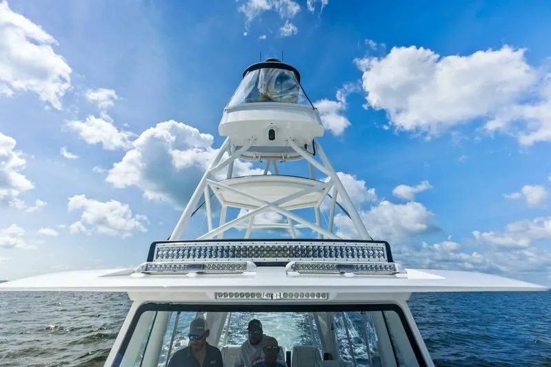 Fish Wish Yacht Photos Pics 2023 SeaVee 450z boat on open water under a bright blue sky.