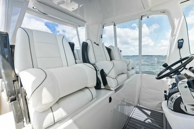 Fish Wish Yacht Photos Pics Interior of 2023 SeaVee 450z boat with luxurious white seating and ocean view.