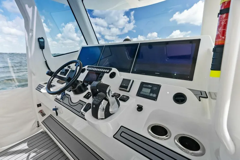 Fish Wish Yacht Photos Pics 2023 SeaVee 450z boat helm with advanced navigation screens and controls.