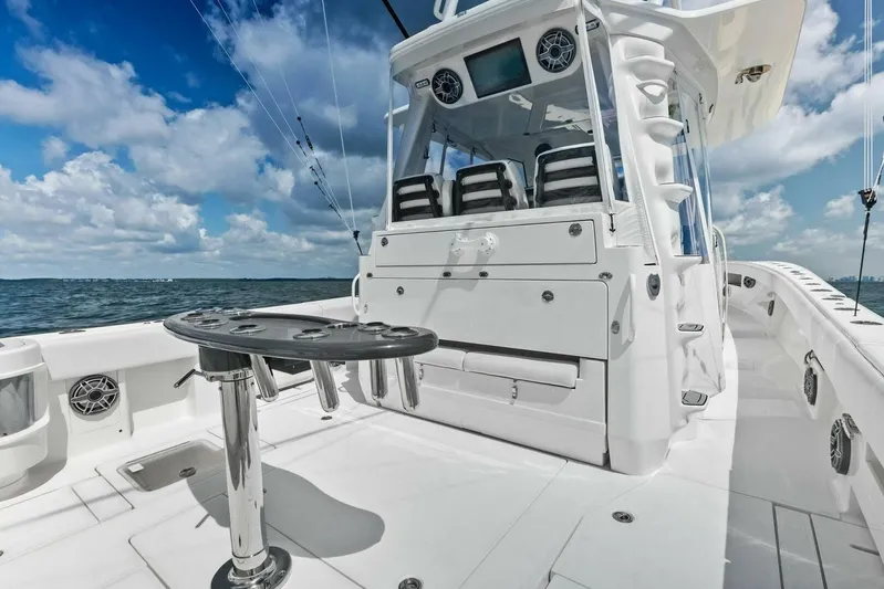 Fish Wish Yacht Photos Pics 2023 SeaVee 450z boat deck with seating, ocean view, and clear sky.