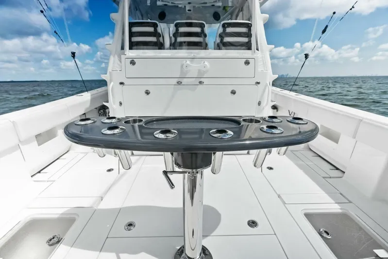 Fish Wish Yacht Photos Pics 2023 SeaVee 450z boat deck with rod holders, ocean view, and clear sky.