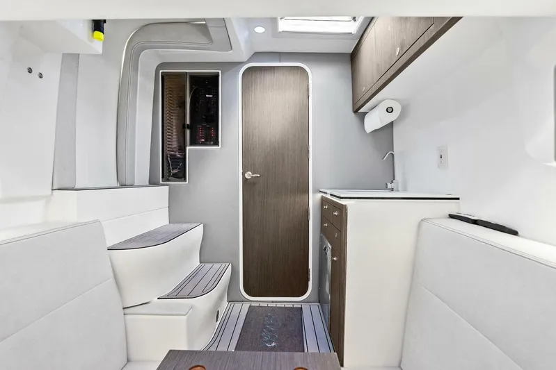 Fish Wish Yacht Photos Pics 2023 SeaVee 450z interior cabin with modern kitchenette and seating area.