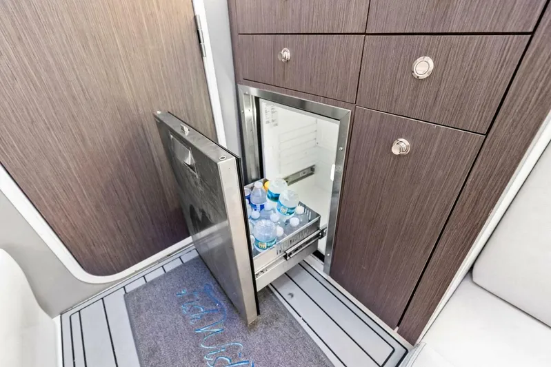Fish Wish Yacht Photos Pics 2023 SeaVee 450z interior with open fridge, stocked with bottled water.