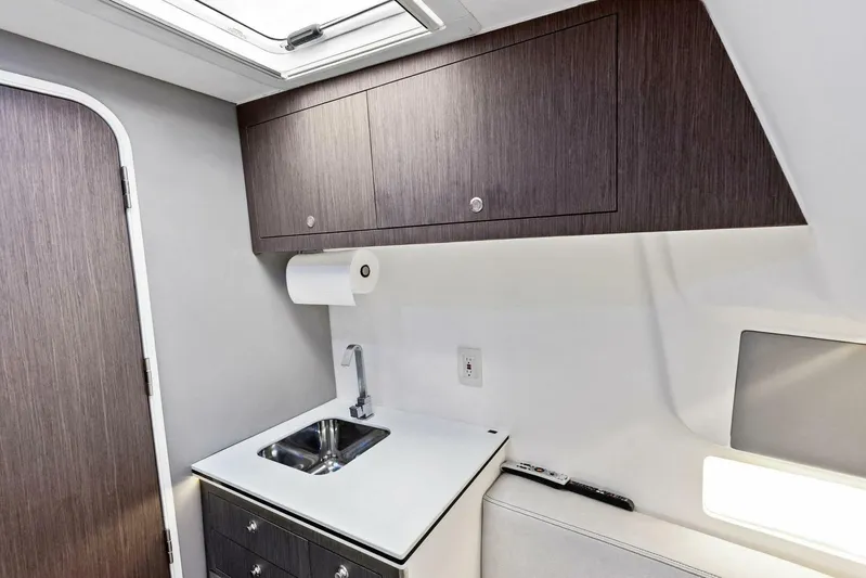 Fish Wish Yacht Photos Pics 2023 SeaVee 450z interior with modern sink, cabinetry, and natural lighting.