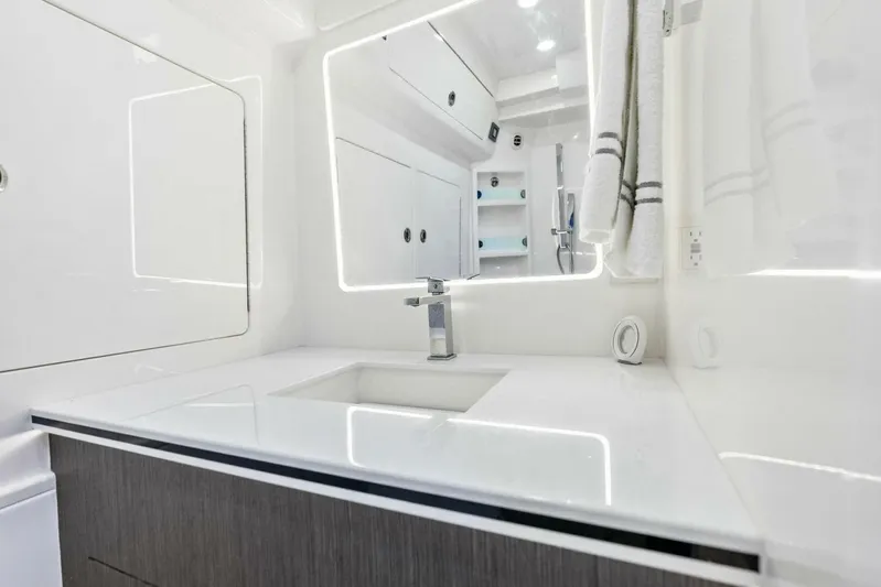 Fish Wish Yacht Photos Pics Luxurious bathroom interior of 2023 SeaVee 450z boat with modern fixtures and lighting.