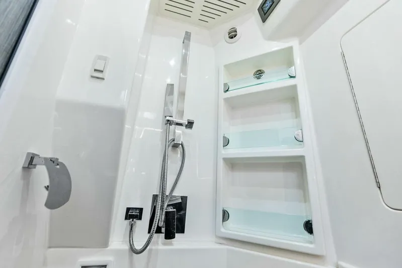Fish Wish Yacht Photos Pics 2023 SeaVee 450z boat interior shower with modern fixtures and shelving.