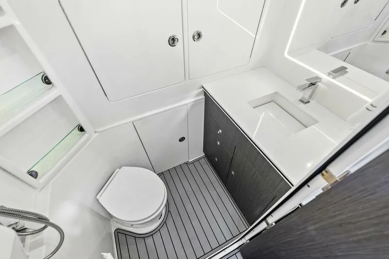 Fish Wish Yacht Photos Pics 2023 SeaVee 450z boat bathroom with modern fixtures and sleek design.