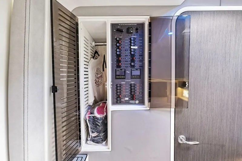 Fish Wish Yacht Photos Pics 2023 SeaVee 450z interior showing electrical panel and storage compartment.