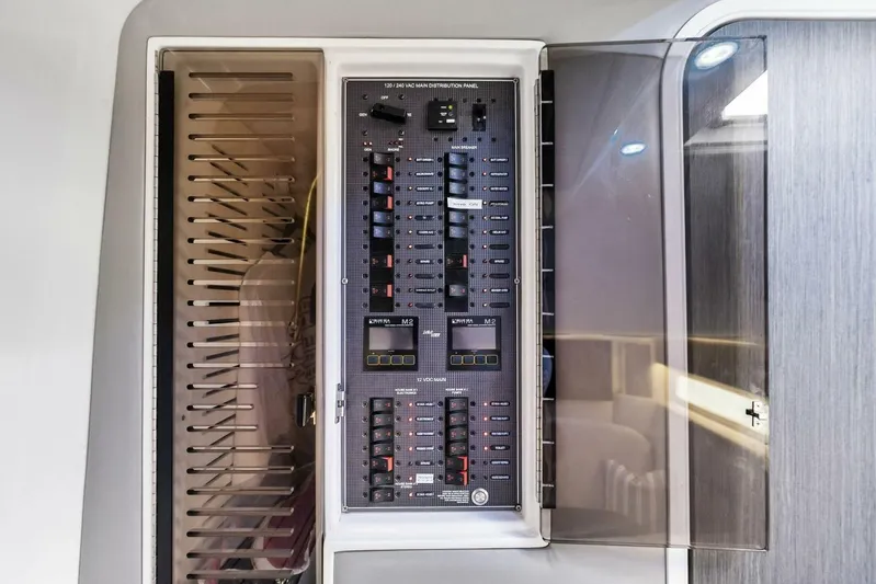 Fish Wish Yacht Photos Pics Electrical distribution panel on 2023 SeaVee 450z boat, showcasing circuit breakers and controls.