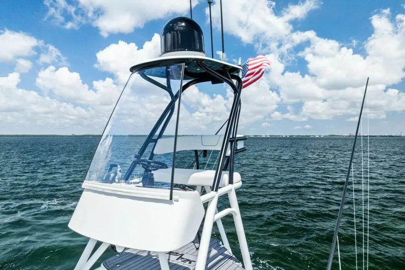 Fish Wish Yacht Photos Pics 2023 SeaVee 450z boat on open water with American flag, clear sky.