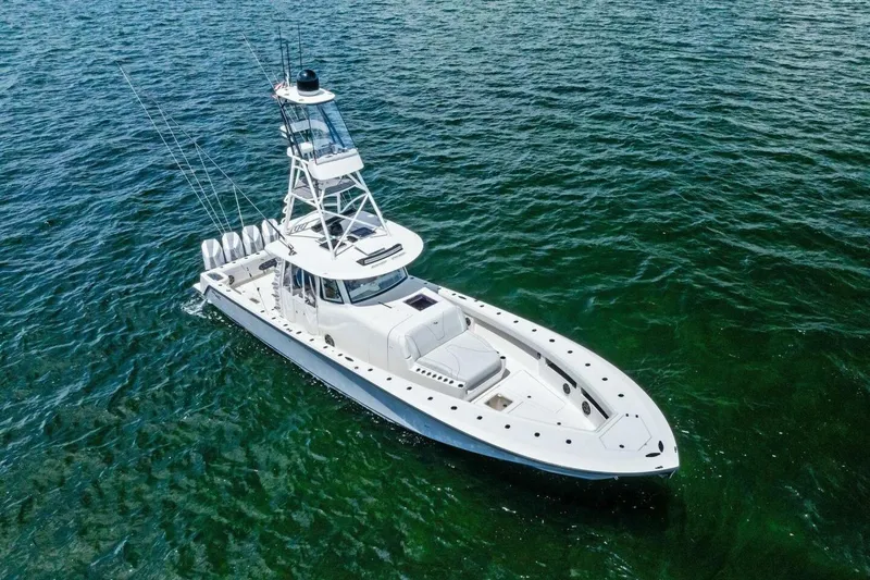 Fish Wish Yacht Photos Pics 2023 SeaVee 450z boat on open water, featuring sleek design and multiple engines.