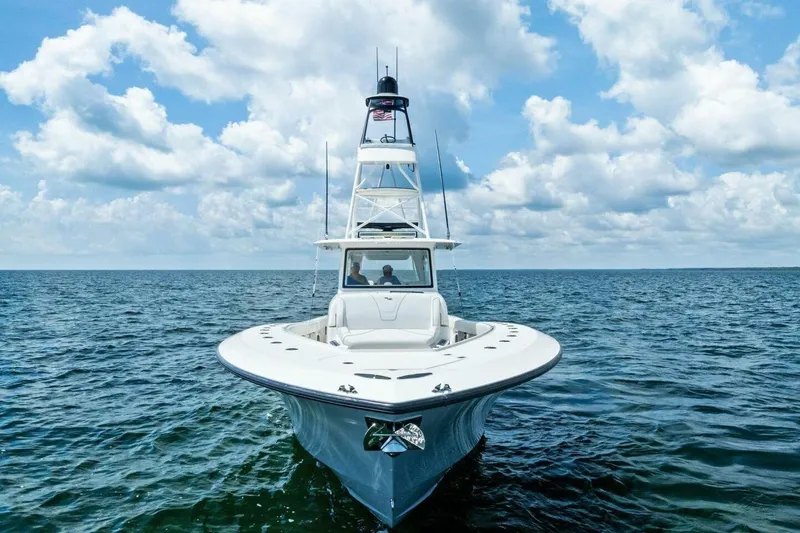 Fish Wish Yacht Photos Pics 2023 SeaVee 450z boat on open water under a partly cloudy sky.