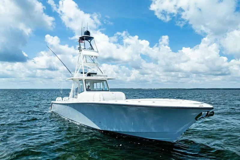 Fish Wish Yacht Photos Pics 2023 SeaVee 450z boat on open water under a blue sky with clouds.