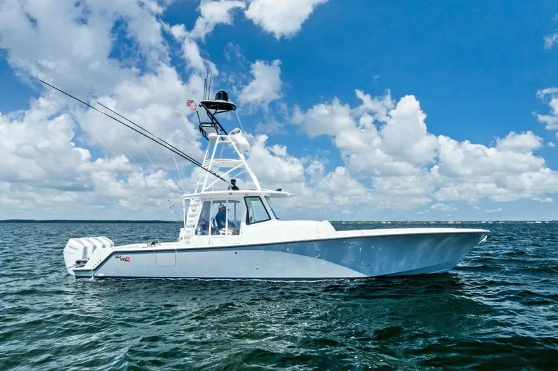 Fish Wish Yacht Photos Pics 2023 SeaVee 450z boat cruising on open water under a clear blue sky.