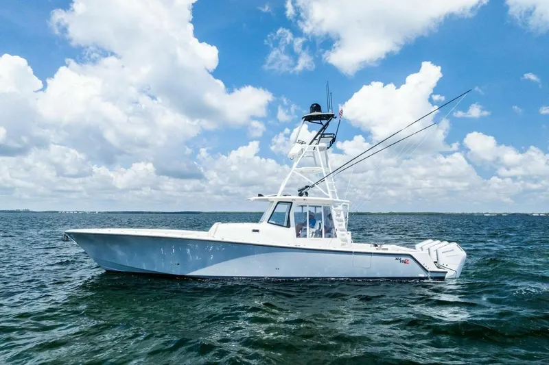Fish Wish Yacht Photos Pics 2023 SeaVee 450z boat cruising on open water under a cloudy sky.