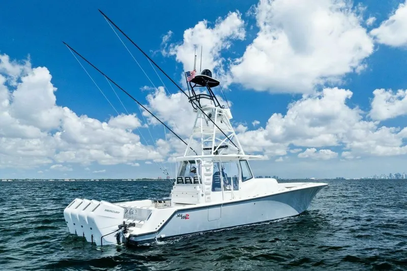 Fish Wish Yacht Photos Pics 2023 SeaVee 450z boat on open water under a clear blue sky.