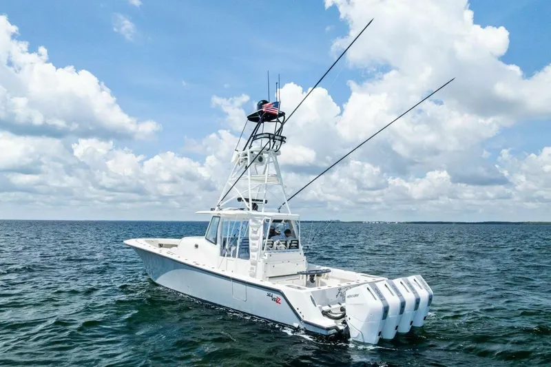 Fish Wish Yacht Photos Pics 2023 SeaVee 450z boat on open water under a partly cloudy sky.