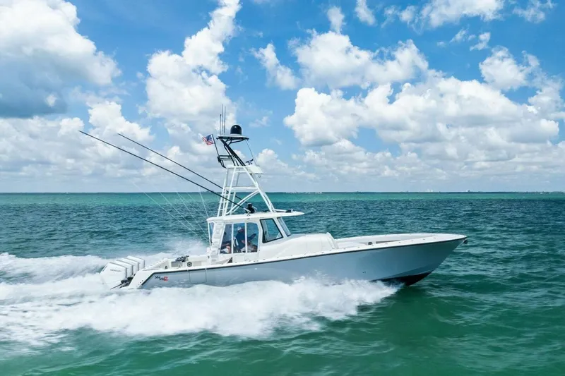 Fish Wish Yacht Photos Pics 2023 SeaVee 450z boat cruising on open ocean under blue sky.