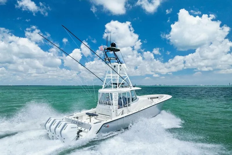 Fish Wish Yacht Photos Pics 2023 SeaVee 450z boat cruising on open water under a clear blue sky.
