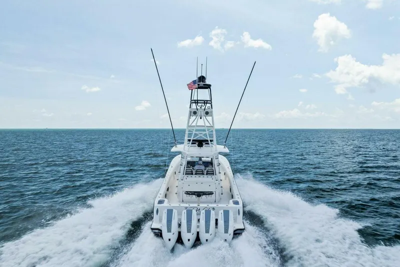 Fish Wish Yacht Photos Pics 2023 SeaVee 450z boat cruising on open ocean with American flag.