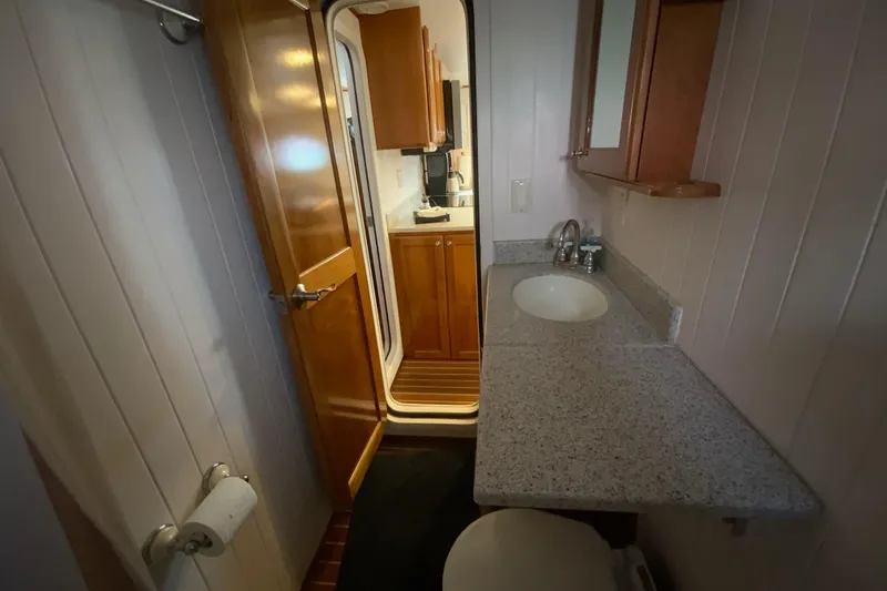 Lone Star (former/recently Andros) Yacht Photos Pics Bathroom interior of 2008 Great Harbour N37 yacht with sink and wooden cabinetry.