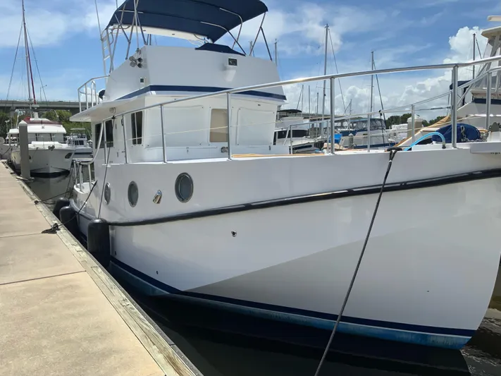 Lone Star (former/recently Andros) Yacht Photos Pics 2008 Great Harbour N37 yacht docked at marina, featuring white hull and blue canopy.