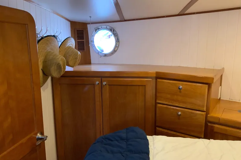 Lone Star (former/recently Andros) Yacht Photos Pics Cozy cabin interior of 2008 Great Harbour N37 with wooden cabinets and porthole.