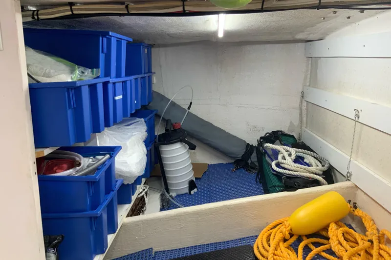 Lone Star (former/recently Andros) Yacht Photos Pics Storage area on a 2008 Great Harbour N37 boat with blue bins and nautical equipment.