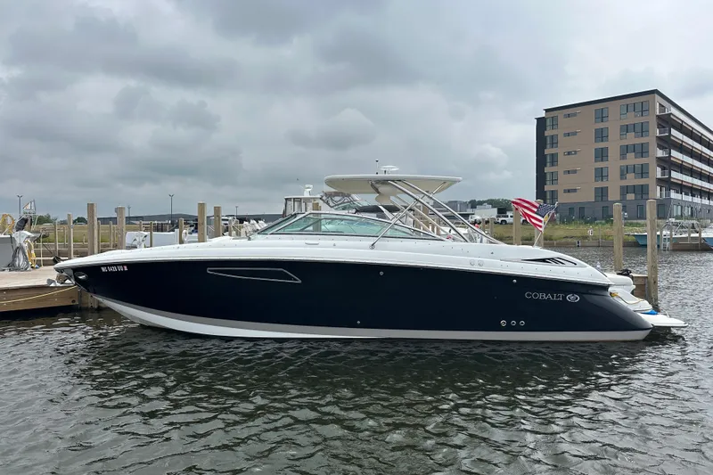  Yacht Photos Pics 2015 Cobalt 336 boat docked at marina, cloudy sky background.