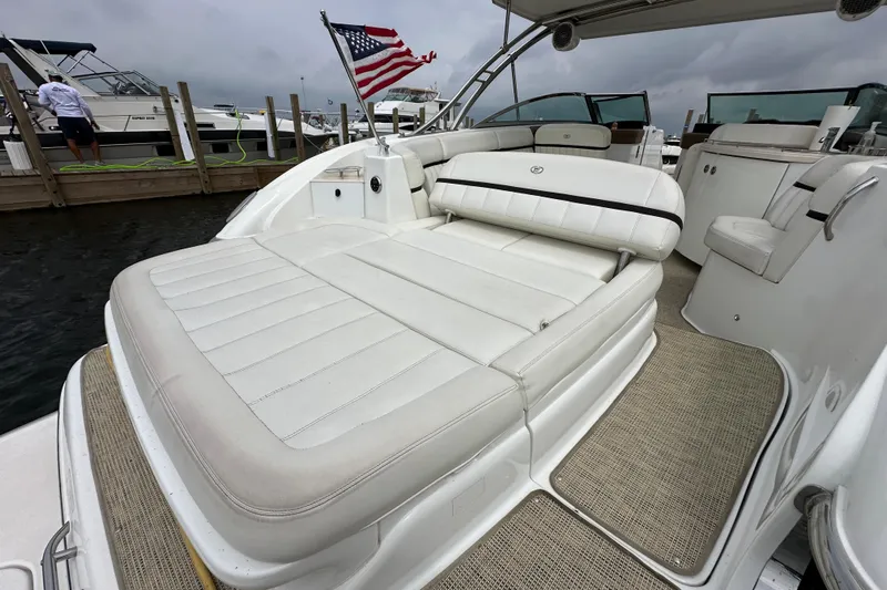  Yacht Photos Pics 2015 Cobalt 336 boat with white seating, American flag, docked at marina.