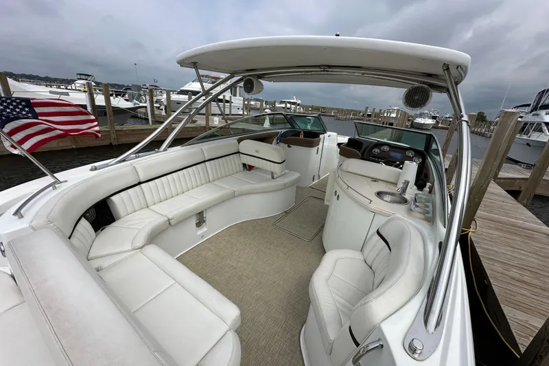  Yacht Photos Pics 2015 Cobalt 336 boat interior with white seating and American flag at dock.