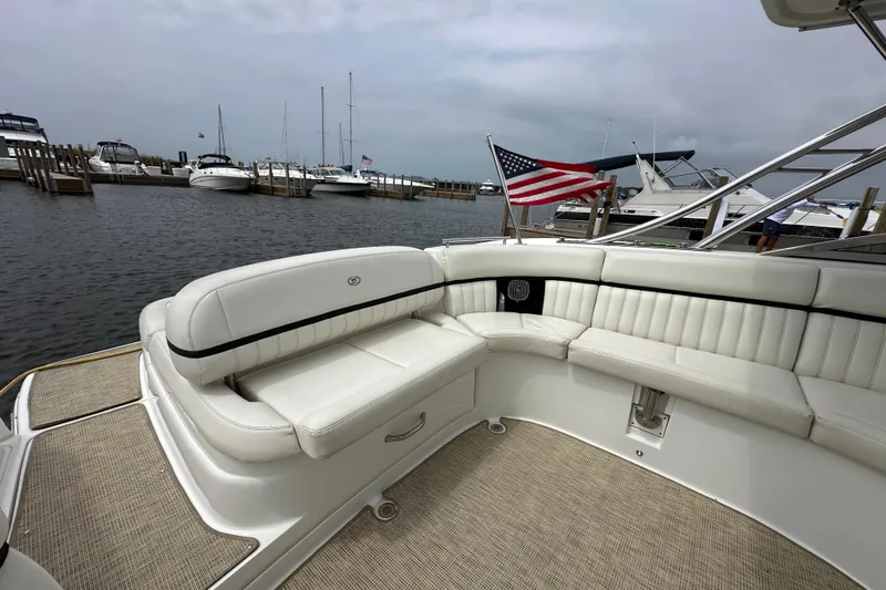  Yacht Photos Pics 2015 Cobalt 336 boat with white seating, docked at a marina with American flag.