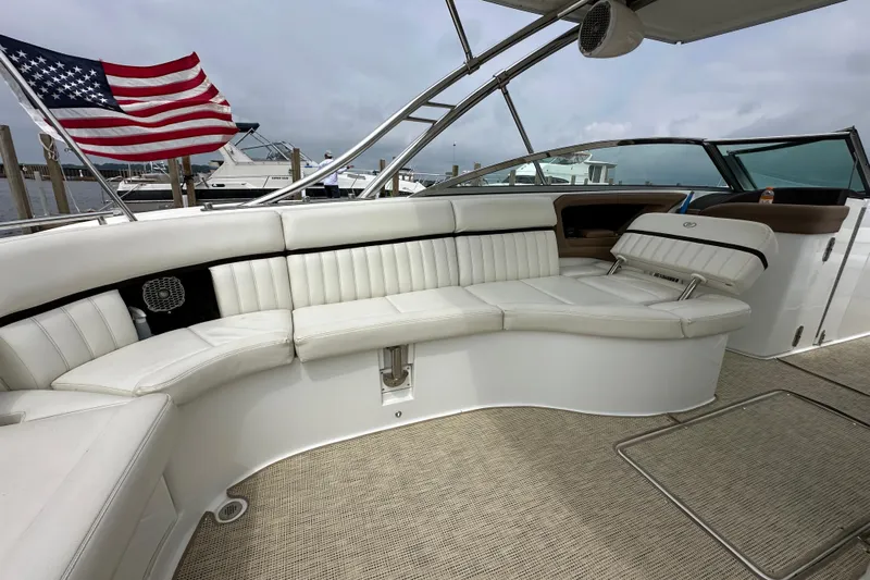  Yacht Photos Pics Luxurious 2015 Cobalt 336 boat interior with white seating and American flag in background.