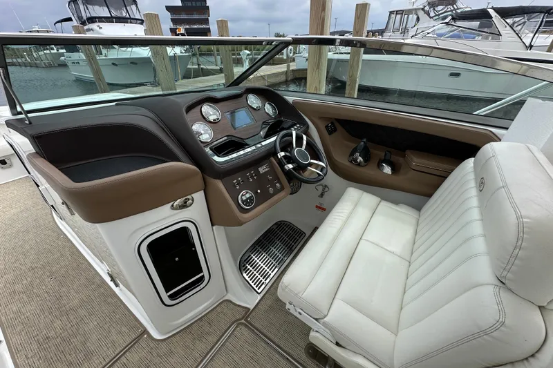  Yacht Photos Pics 2015 Cobalt 336 boat cockpit with steering wheel and control panel, docked at marina.