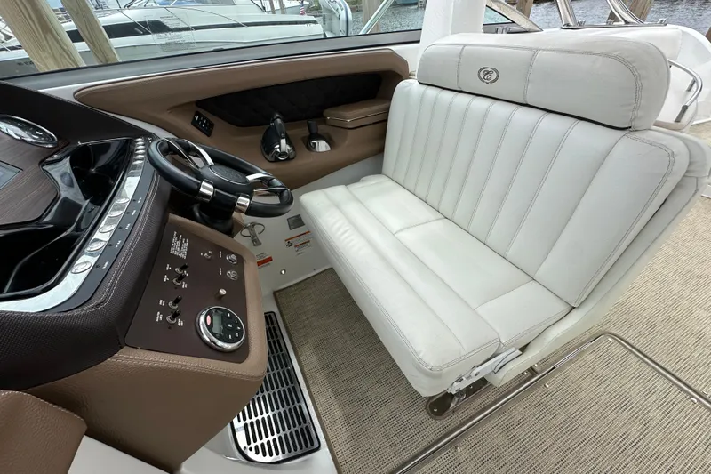  Yacht Photos Pics 2015 Cobalt 336 boat interior with white leather seating and modern dashboard controls.