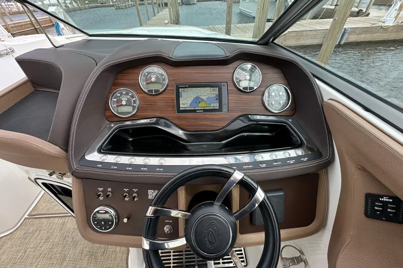  Yacht Photos Pics 2015 Cobalt 336 boat dashboard with gauges, GPS, and steering wheel at marina.