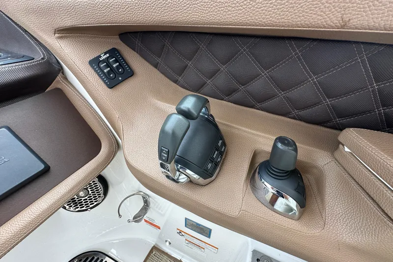  Yacht Photos Pics 2015 Cobalt 336 boat control panel with joystick and throttle, featuring brown leather accents.