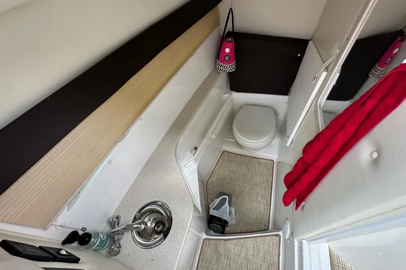  Yacht Photos Pics 2015 Cobalt 336 boat bathroom interior with sink, toilet, and red towel.