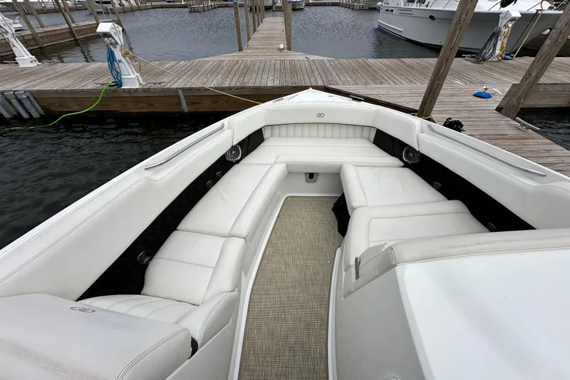  Yacht Photos Pics 2015 Cobalt 336 boat with white seating, docked at a marina.