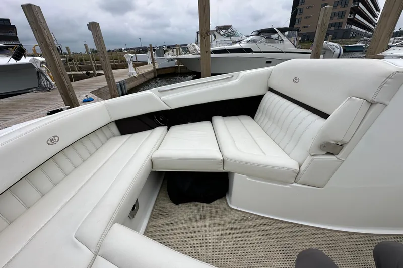  Yacht Photos Pics 2015 Cobalt 336 boat interior with white leather seating at a marina.
