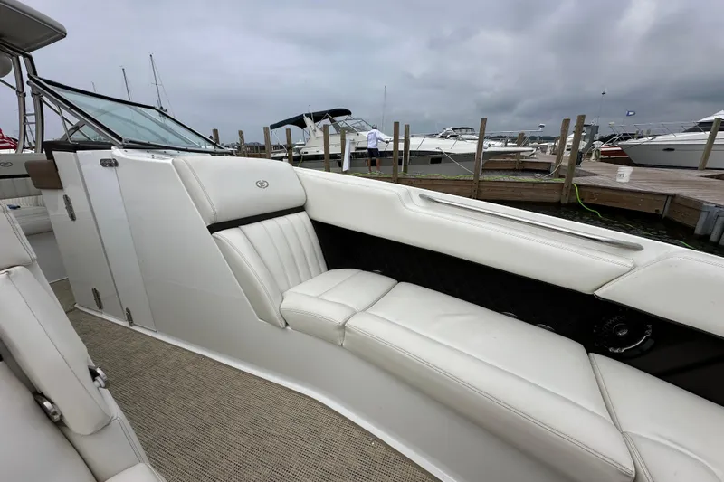  Yacht Photos Pics 2015 Cobalt 336 boat interior with white leather seating at a marina.